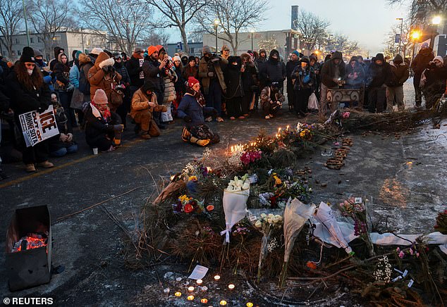 People gather around a makeshift memorial at the site where Alex Pretti was fatally shot
