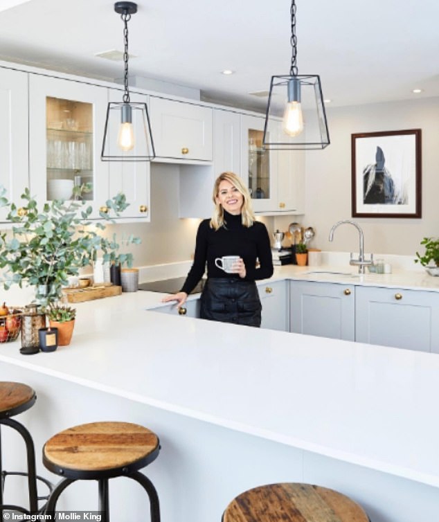 Mollie King, 38, showed off a sleek, ivory-hued kitchen - which includes modern lighting fixtures