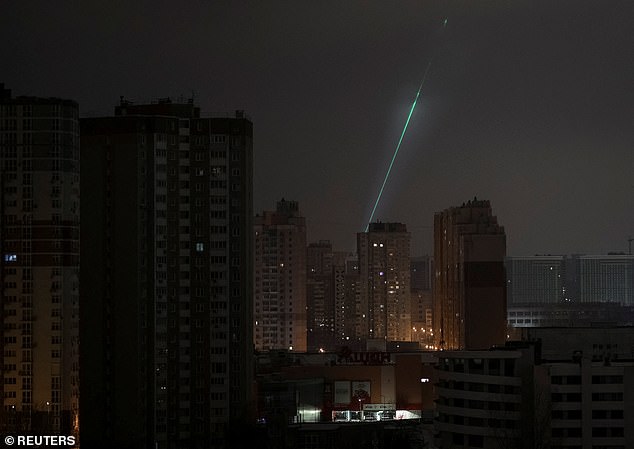 Ukrainian service personnel use a searchlight as they search for drones in the sky over the city during Russian drone and missile strikes, amid Russia's attack on Ukraine, in Kyiv, Ukraine January 24, 2026