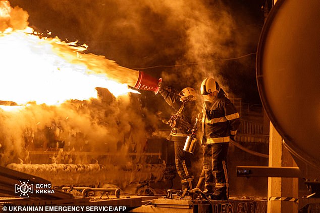 Ukrainian rescuers work to extinguish a burning petrol truck following an air attack in Kyiv, amid the Russian invasion of Ukraine. Russian strikes killed one person and injured 23 others in Ukraine's capital and the northeastern city of Kharkiv overnight, authorities said early on January 24, 2026