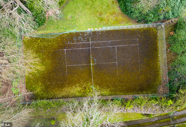 Neighbours say moss and weeds have grown over the tennis court which Sir Bruce, a keen tennis fan, frequently used whilst living at the property