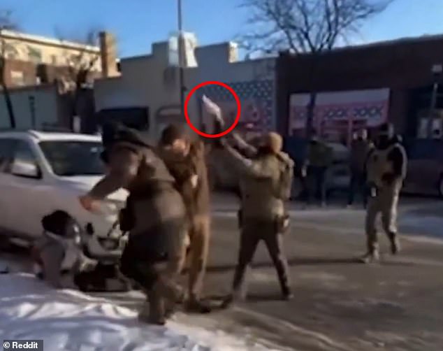 Pretti can be seen holding a bright, shiny object during a struggle with federal agents