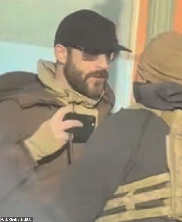 Alex Jeffrey Pretti, 37, could be seen in the street filming with his phone while a small group confronts a federal agent. His other hand appeared to be empty