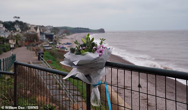 Pictured: Flowers left at the beacher where Mr Upham had gone to the beach with friends on Christmas Day morning for the annual swim