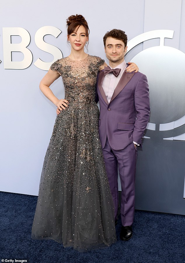 There are only two inches keeping Erin Darke and Daniel Radcliffe apart, but because she loves to model heels, it appears to be more. Seen in 2024