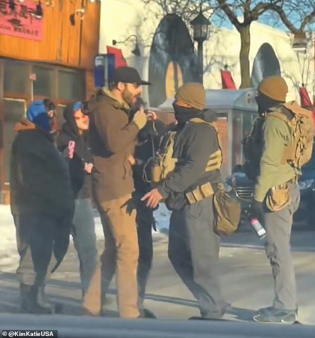 Alex Jeffrey Pretti, 37, could be seen on the street filming with his phone while a small group confronts a federal agent. His other hand appeared to be empty