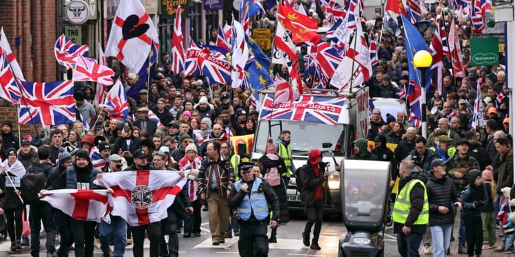 Thousands of protesters take to streets after 27 migrants moved into former military camp in dead of night