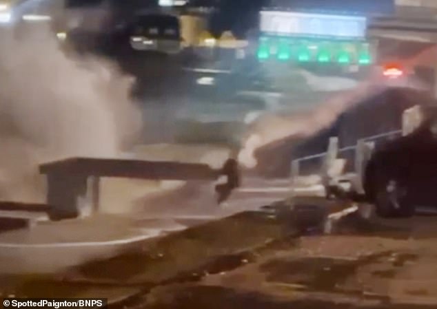The footage shows the youngster walking right to the edge of the wall in Paignton, Devon, crouching down as waves crash over the side before she runs for cover