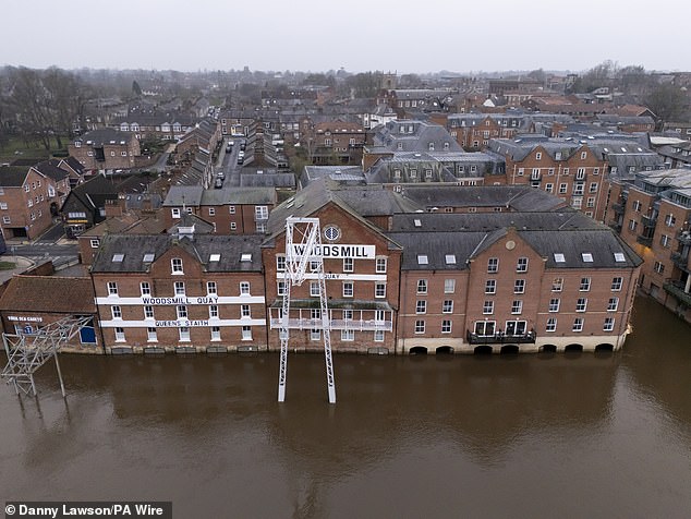 The bottom of the Woodsmill Quay building is hit by flood water, reaching its doors on the ground floor