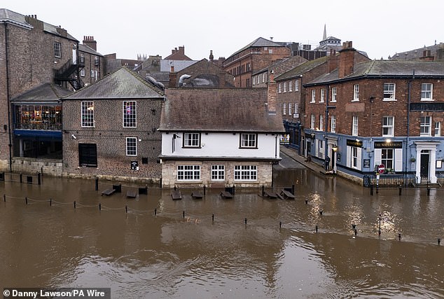 Benches outside a property in York are submerged in water after severe flooding in the area