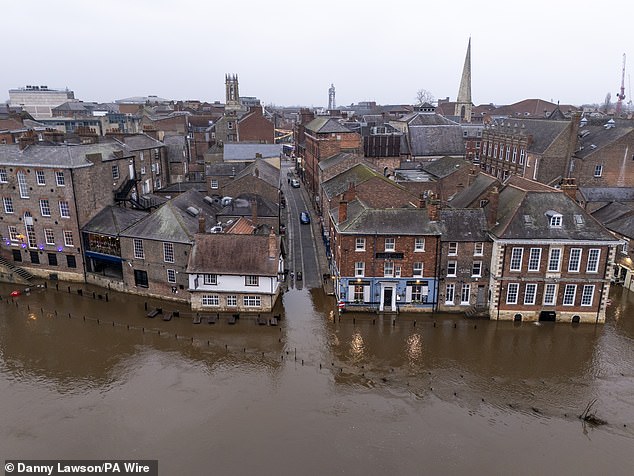 The water reaches all the way up to a side street and has directly affected a long row of properties in the city