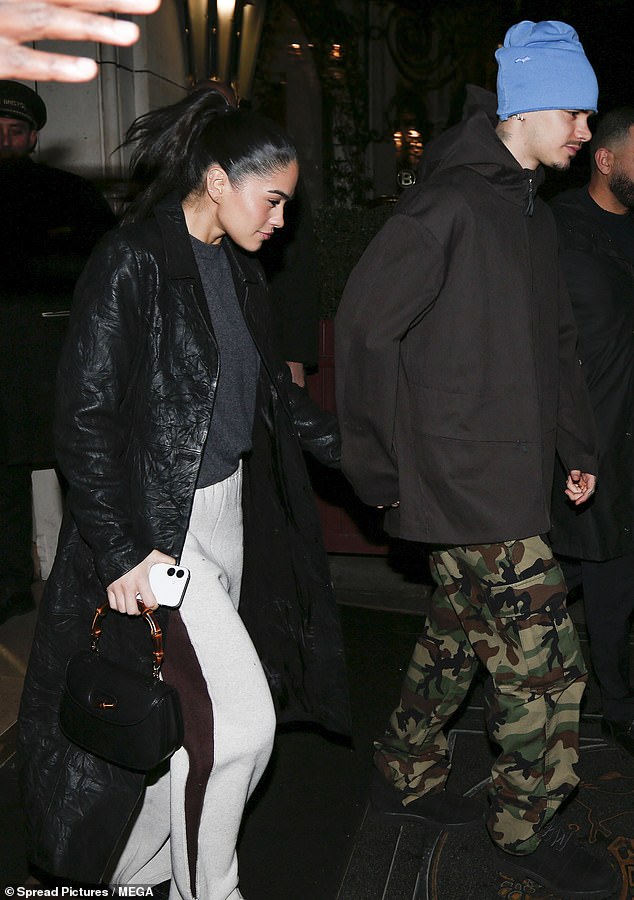 Dressed in a blue beanie and camouflage trousers, Romeo cut a casual figure as he held hands with Kim - who also seemingly came under fire in Brooklyn's statement