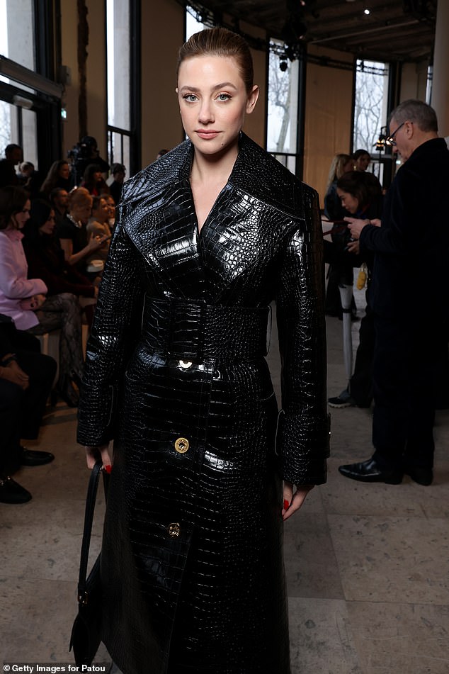 Lili Reinhart turned heads in her crocodile print trench coat as she hit the front row for the Patou show