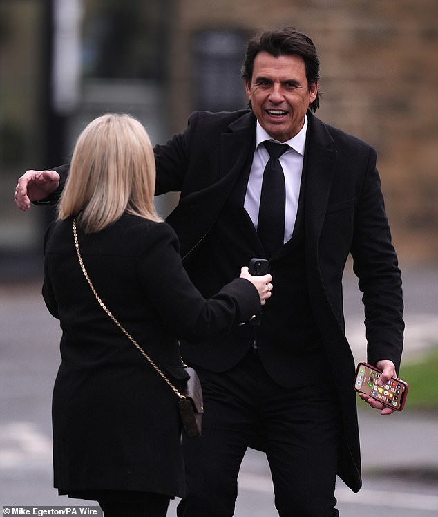 Former Wales player and manager Chris Coleman hugs a friend as he pays his respects to Terry Yorath