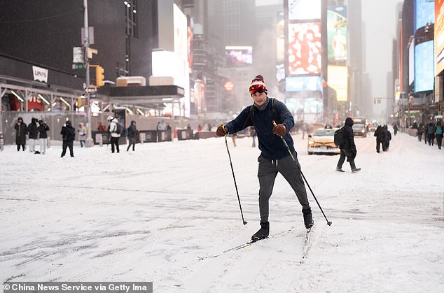 NEW YORK, NY - JANUARY 25: A person skis on double boards at Times Square on January 25, 2026 in New York City. A historic winter storm is sweeping across the Midwest and eastern parts of the United States on January 25, causing unprecedented travel chaos. (Photo by Liao Pan/China News Service/VCG via Getty Images)