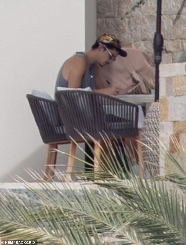 The pair were later seen walking along the dock together before boarding a boat marked Cabo San Lucas, MX, where they appeared comfortable and familiar with the crew