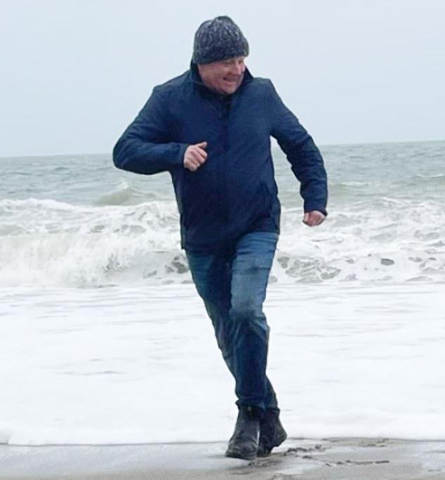 John Bruce pictured running along a beach in a rare social media photo