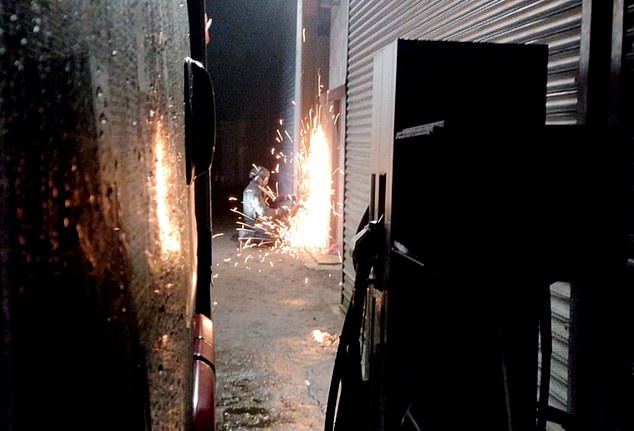 Police breaking into a container during one of the raids, which took place across Worcestershire, Herefordshire and Shropshire