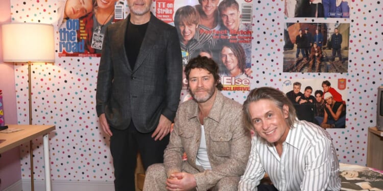 'Emotional' Take That pose in 'fan's bedroom from 1990s' at premiere of warts-and-all Netflix series