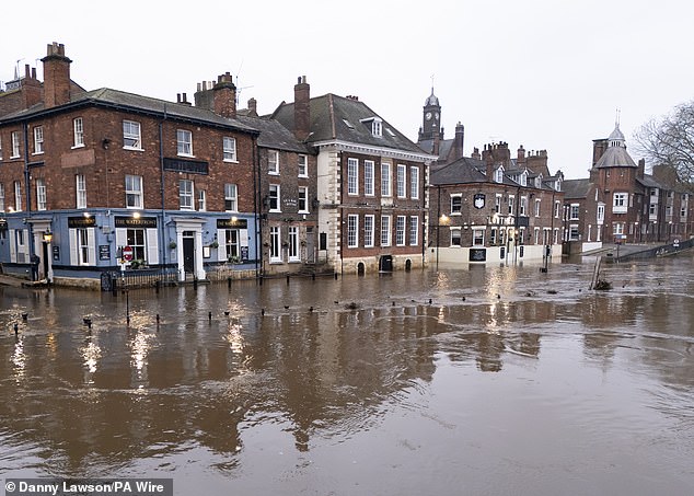 More than 100 flood alerts have been put in place across the UK. Pictured: Flooding in York after the River Ouse burst its banks on Sunday