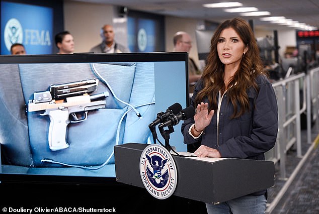 Homeland Security Secretary Kristi Noem displays a picture of Alex Pretti's gun during a news conference at the headquarters for the Federal Emergency Management Agency (FEMA)