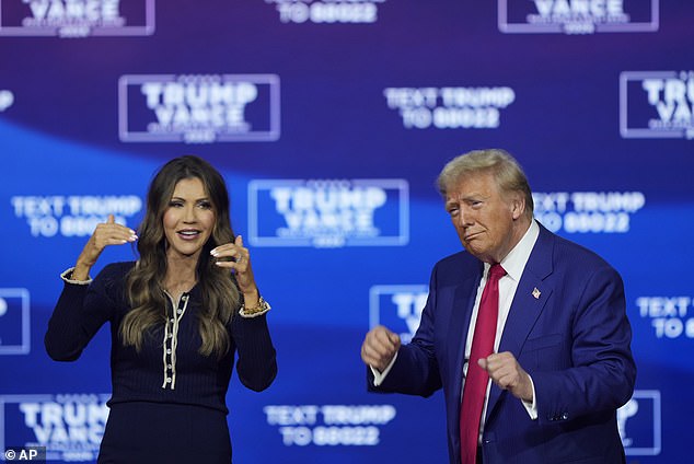 Kristi Noem and President Donald Trump dance to the song 'Y.M.C.A.' at a campaign town hall at the Greater Philadelphia Expo Center & Fairgrounds, Monday, Oct. 14, 2024