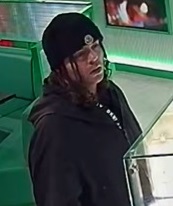 Man in a black beanie and black hoodie looking to the right.