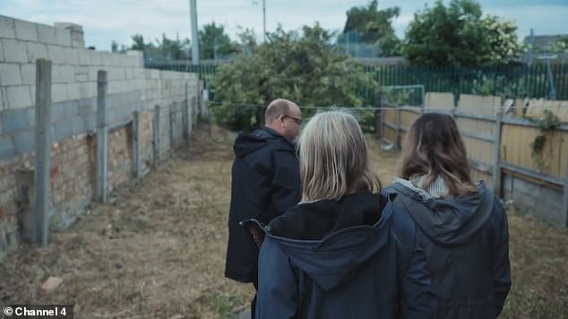 The Bedfordshire Police team look at paving slabs and rubble on and underneath the grass