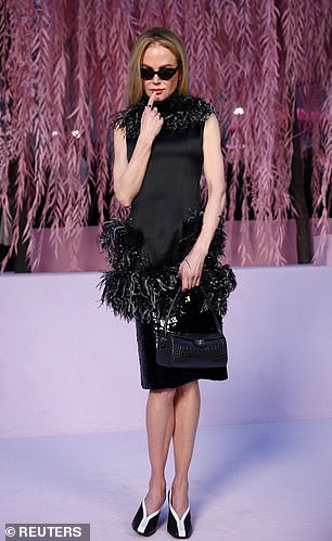 She boosted her height with classic black and white shoes and displayed her smooth visage