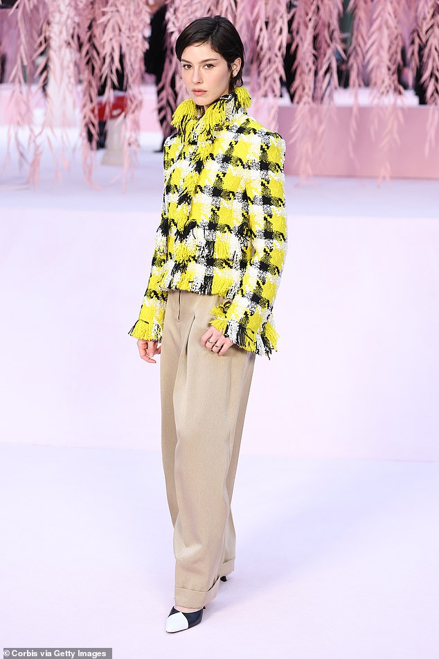 She added beige chinos to the look