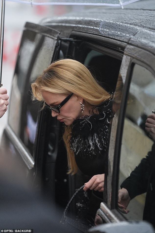 Nicole accessorised with intricate silver earrings