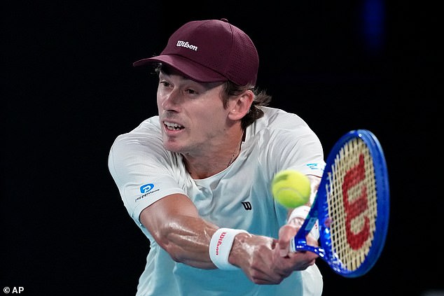 Alex de Minaur of Australia plays a backhand return to Carlos Alcaraz of Spain during their quarterfinal match at the Australian Open tennis championship in Melbourne, Australia, Tuesday, Jan. 27, 2026. (AP Photo/Aaron Favila)