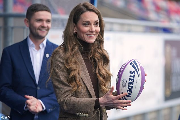 A great sport! Kate holding a rugby ball during her visit to the Wakefield Trinity Rugby League club in West Yorkshire today