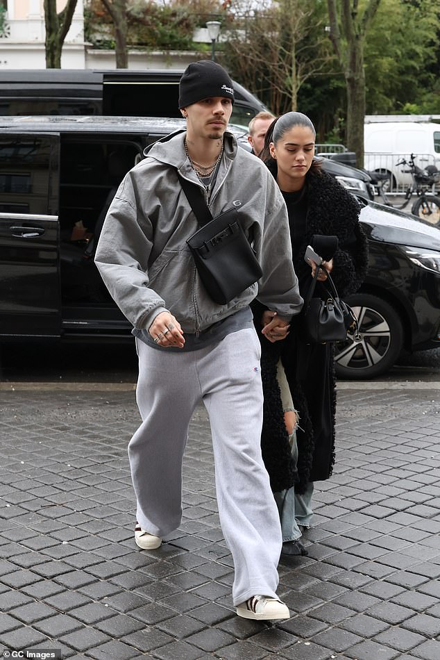 Romeo wore a grey zipped top and white trainers