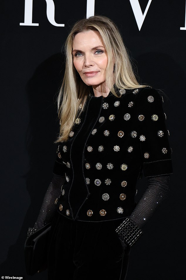 She finished off her ensemble with velvet slim-fit trousers, a pair of pointed patent boots and bling metallic wrist cuffs