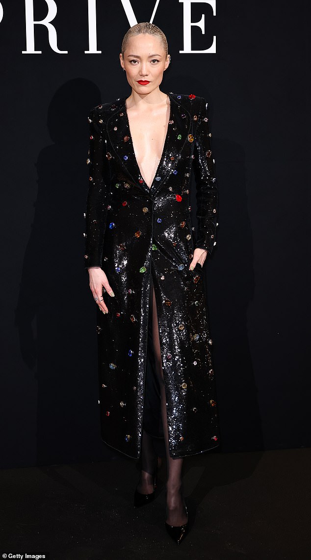 French actress Pom Klementieff, 39, injected a pop of colour into proceedings in a black sequin plunging gown featuring bright coloured jewelled brooches