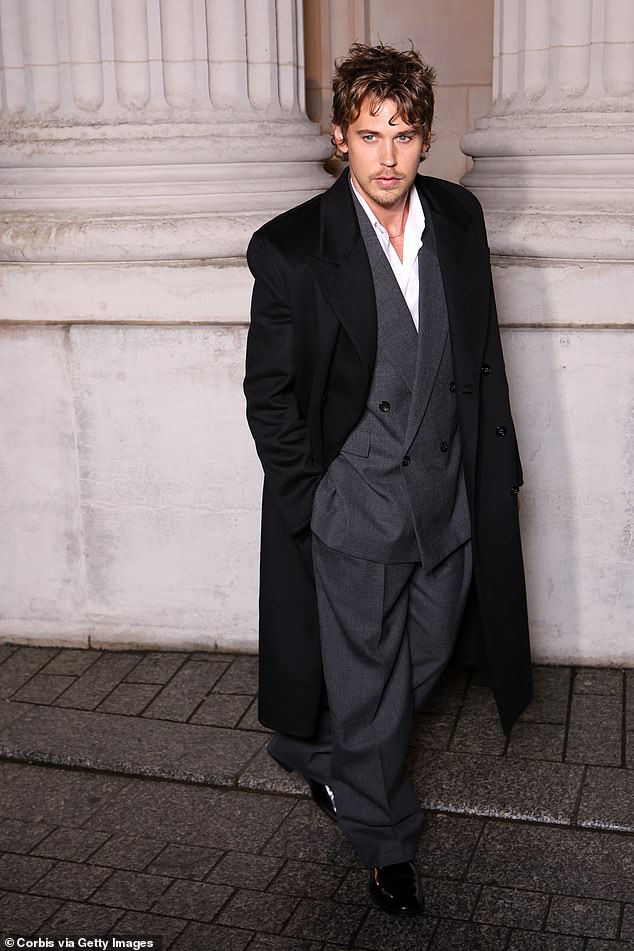 Austin Butler cut a handsome figure in an oversized grey suit and black coat from the designer