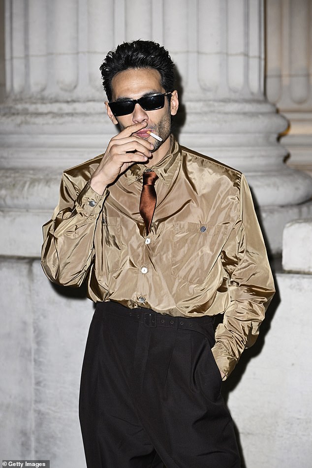 Diego Calva smoked a cigarette outside the venue