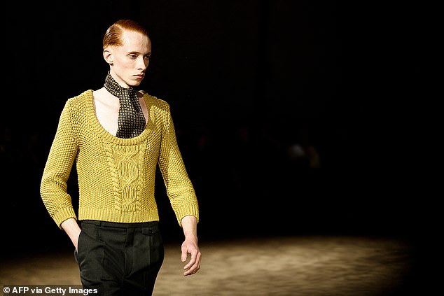 One model hit the runway in a mustard yellow knitted jumper and polka dot silk scarf