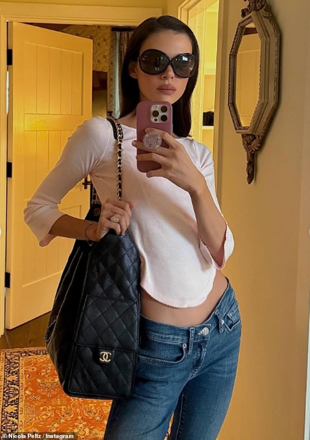 Nicola shared a glamorous mirror selfie as she posed with her black Chanel handbag