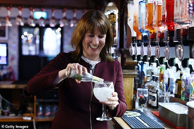 Ms Reeves pours a gin and tonic during a visit to the Goldsmiths Arms pub in Penge following the government's announcement on a pub support package in London on Tuesday