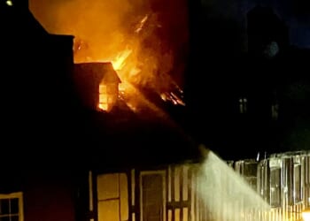 Woman killed in horror blaze that ripped through town centre flat in 'critical incident' as 10 fire engines scrambled
