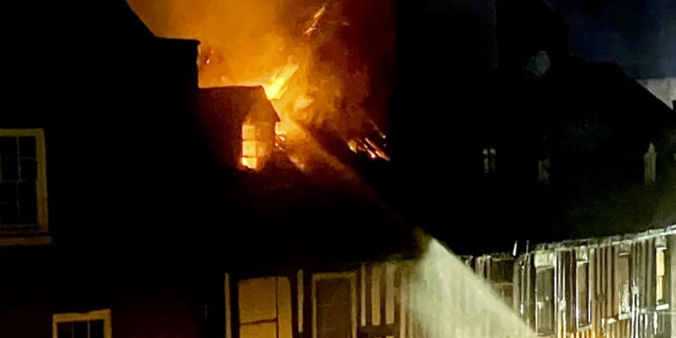 Woman killed in horror blaze that ripped through town centre flat in 'critical incident' as 10 fire engines scrambled