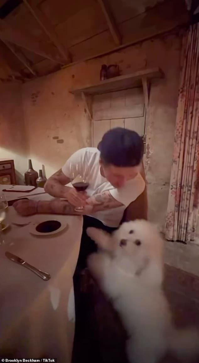 Brooklyn holds a glass of red wine as he poses for a photo at the San Ysidro Ranch in Montecito