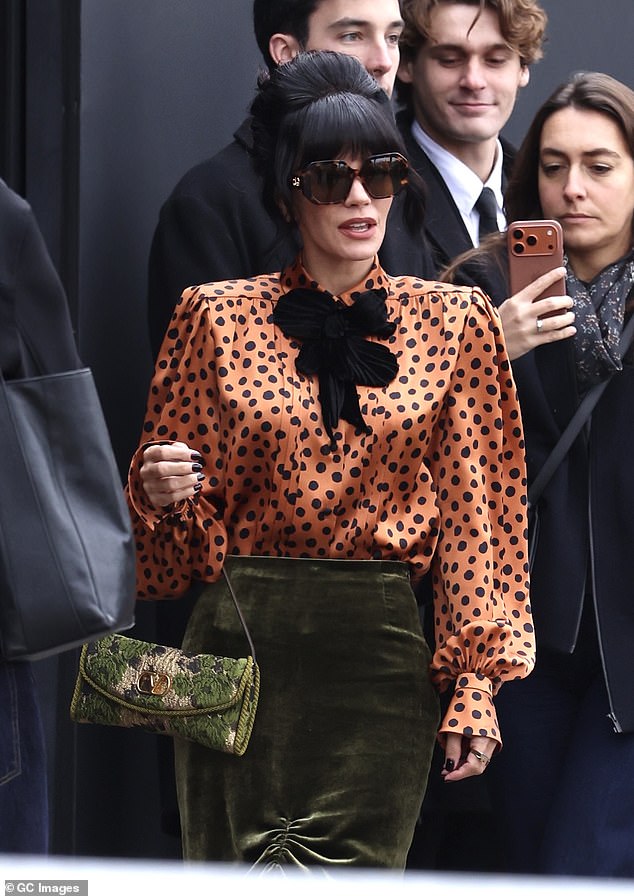 Lily made sure to turned heads in the vibrant blouse, which boasted a black neck tie and large shoulder pads