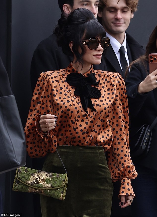 The actress rocked a stylish 60s hairstyle with her dark tresses backcombed high in a bun with her fringe framing her face