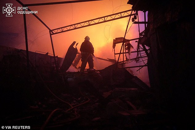 A firefighter works in a residential area damaged during overnight Russian drone strikes, amid Russia's attack on Ukraine, in Odesa, Ukraine January 28, 2026