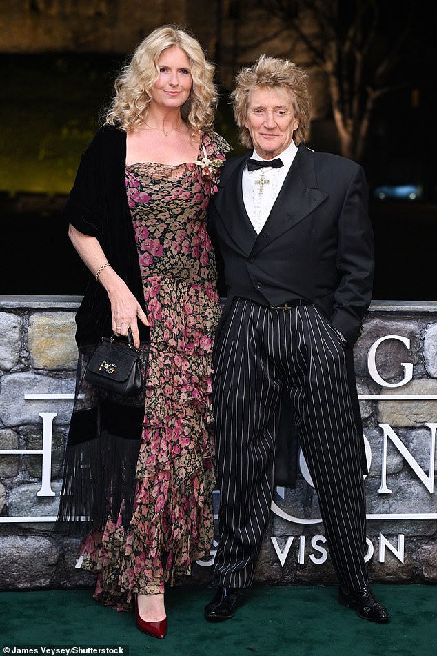 Rod Stewart was also seen with his wife Penny Lancaster, with the rocker wearing a religious cross necklace, lace shirt and pinstripe trousers