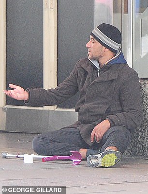 Petru begs on the pavement outside Selfridges with a pink walking stick, pretending to be disabled in order to get more cash from passersby