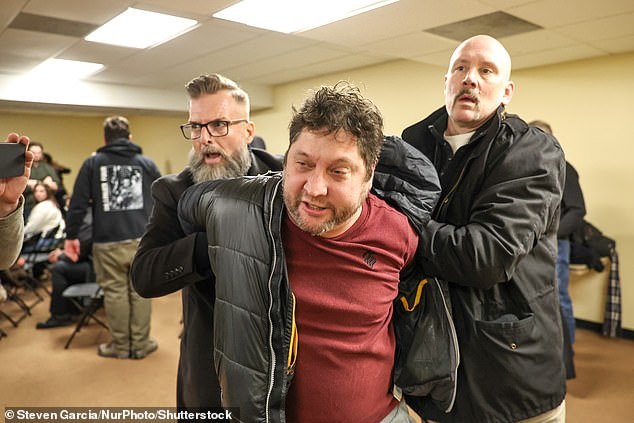 The syringe carried by 55-year-old Anthony J. Kazmierczak (pictured center) is believed to have been filled with apple cider vinegar